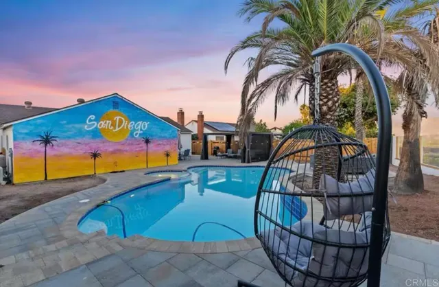 a view of swimming pool with outdoor seating
