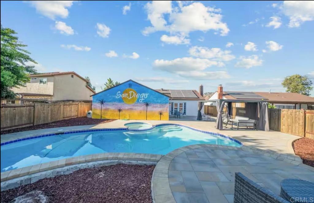 409 Pesca Court Spring Valley, CA 91977 - Photo 23 of 28 a view of a house with swimming pool and sitting area