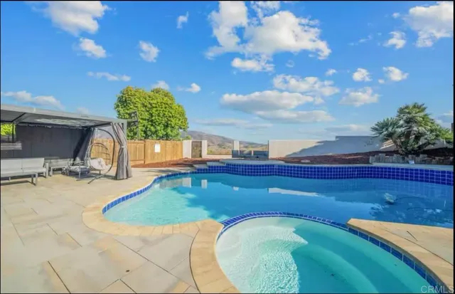 a view of a swimming pool with a yard