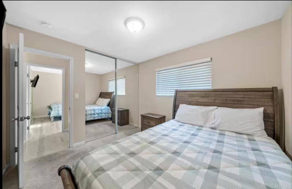409 Pesca Court Spring Valley, CA 91977 - Photo 27 of 28 a bedroom with a large bed and a large mirror