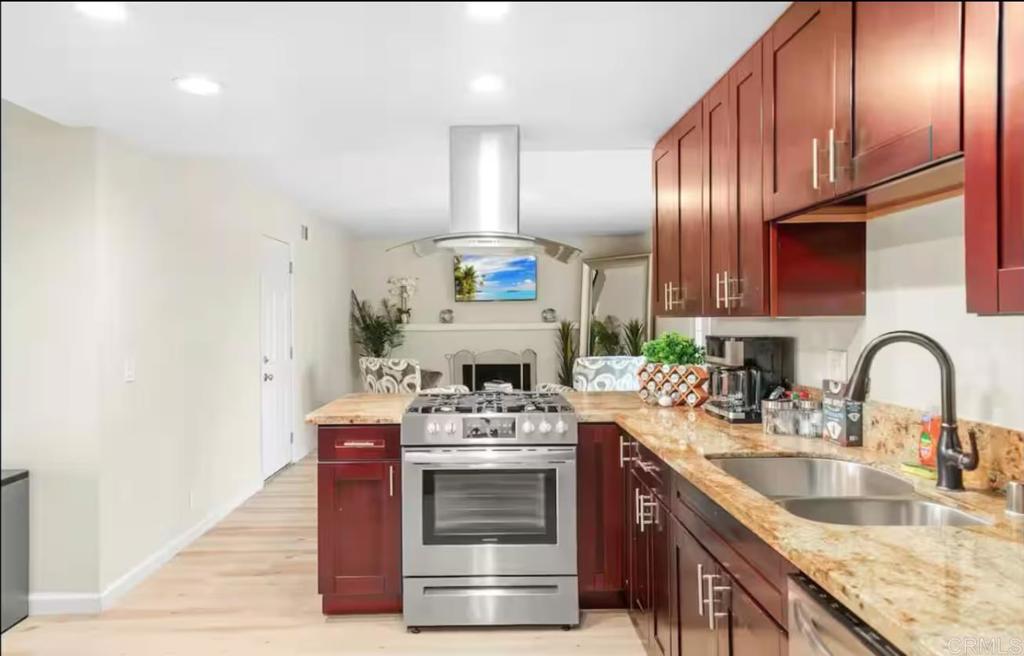 409 Pesca Court Spring Valley, CA 91977 - Photo 7 of 28 a kitchen with stainless steel appliances granite countertop a sink stove and cabinets