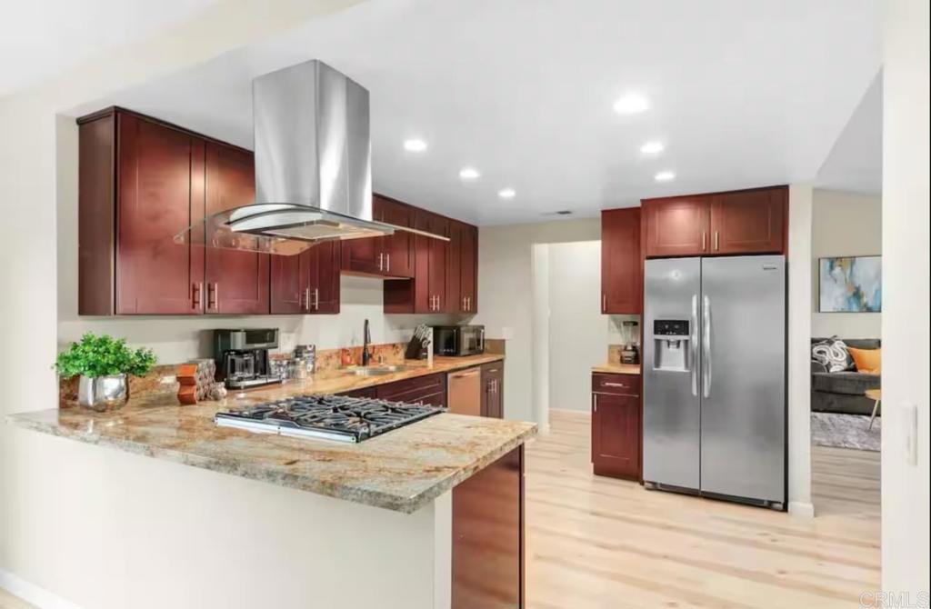 409 Pesca Court Spring Valley, CA 91977 - Photo 8 of 28 a kitchen with stainless steel appliances granite countertop a refrigerator a stove and a wooden floors