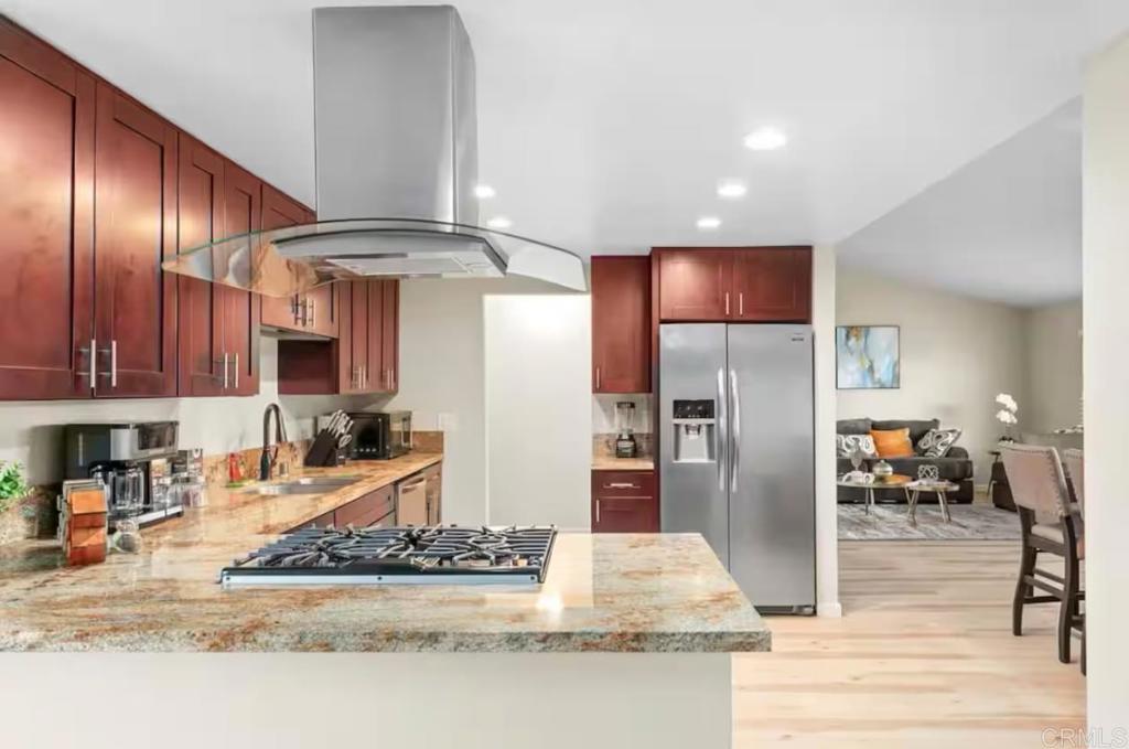 409 Pesca Court Spring Valley, CA 91977 - Photo 10 of 28 a kitchen with stainless steel appliances granite countertop a refrigerator a stove and a sink