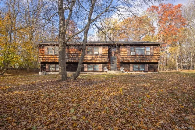 a front view of a house with a yard covered with snow