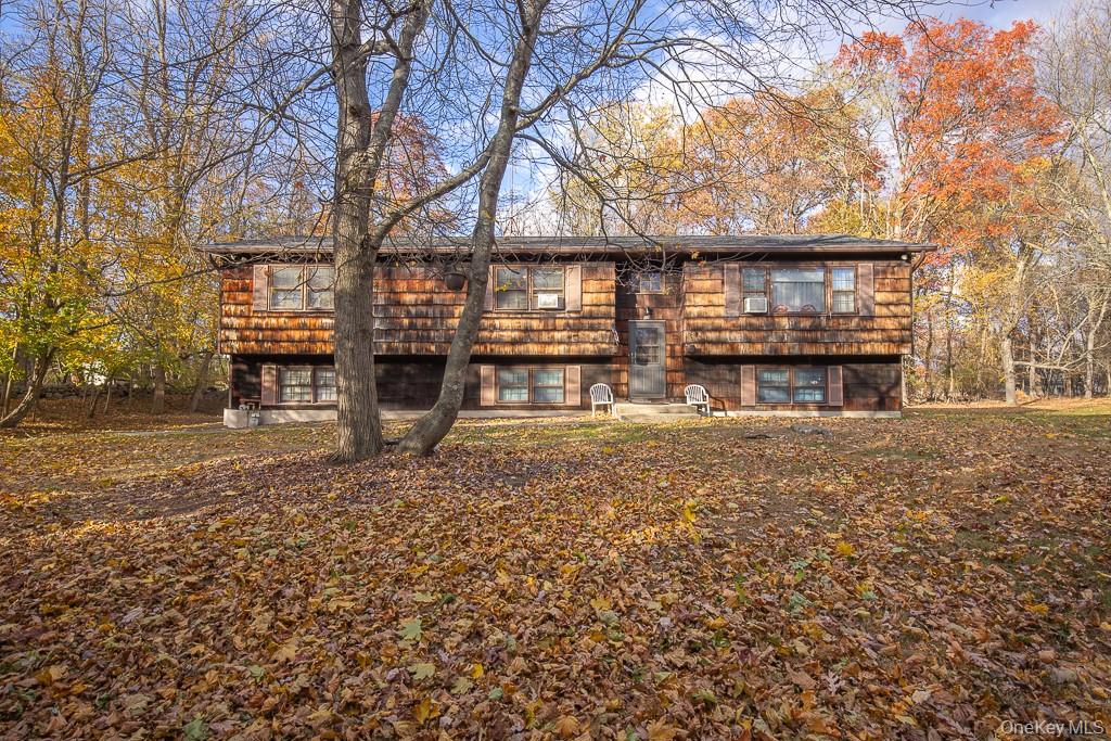 a front view of a house with a yard covered with snow