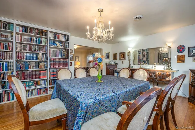a view of a dining room with furniture and a bookshelf