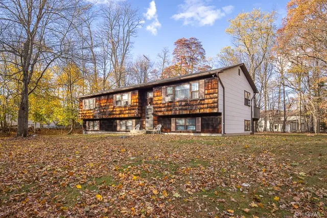 a big house with large windows and palm trees