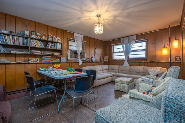 a living room with furniture a chandelier and a rug