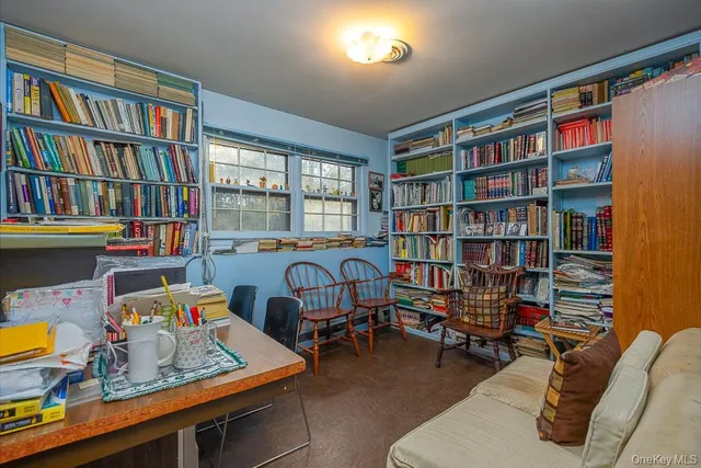a room with furniture workspace and a book shelf