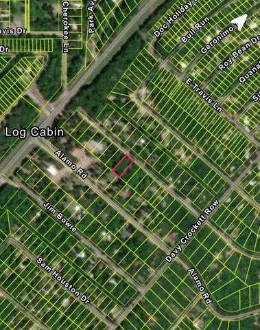 a sign that is sitting on a wall with plants