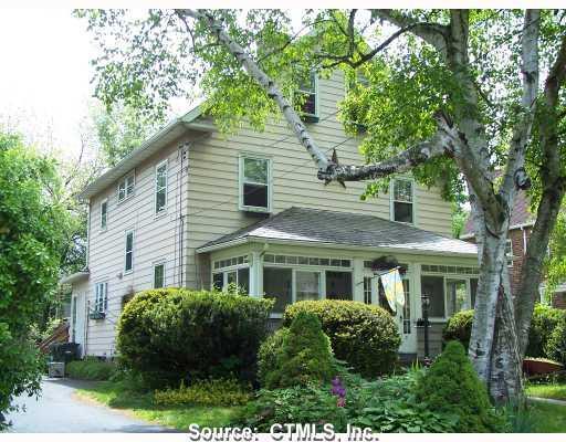 21 Belcher Road Wethersfield, CT 06109 - Photo 1 of 1 a view of a white house next to a yard with plants and trees