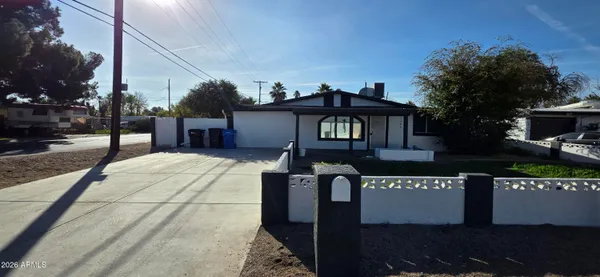 a front view of a house with yard and potted plants