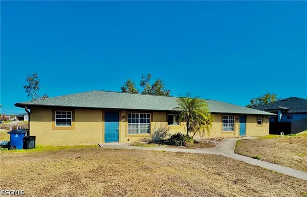 a front view of a house with a yard