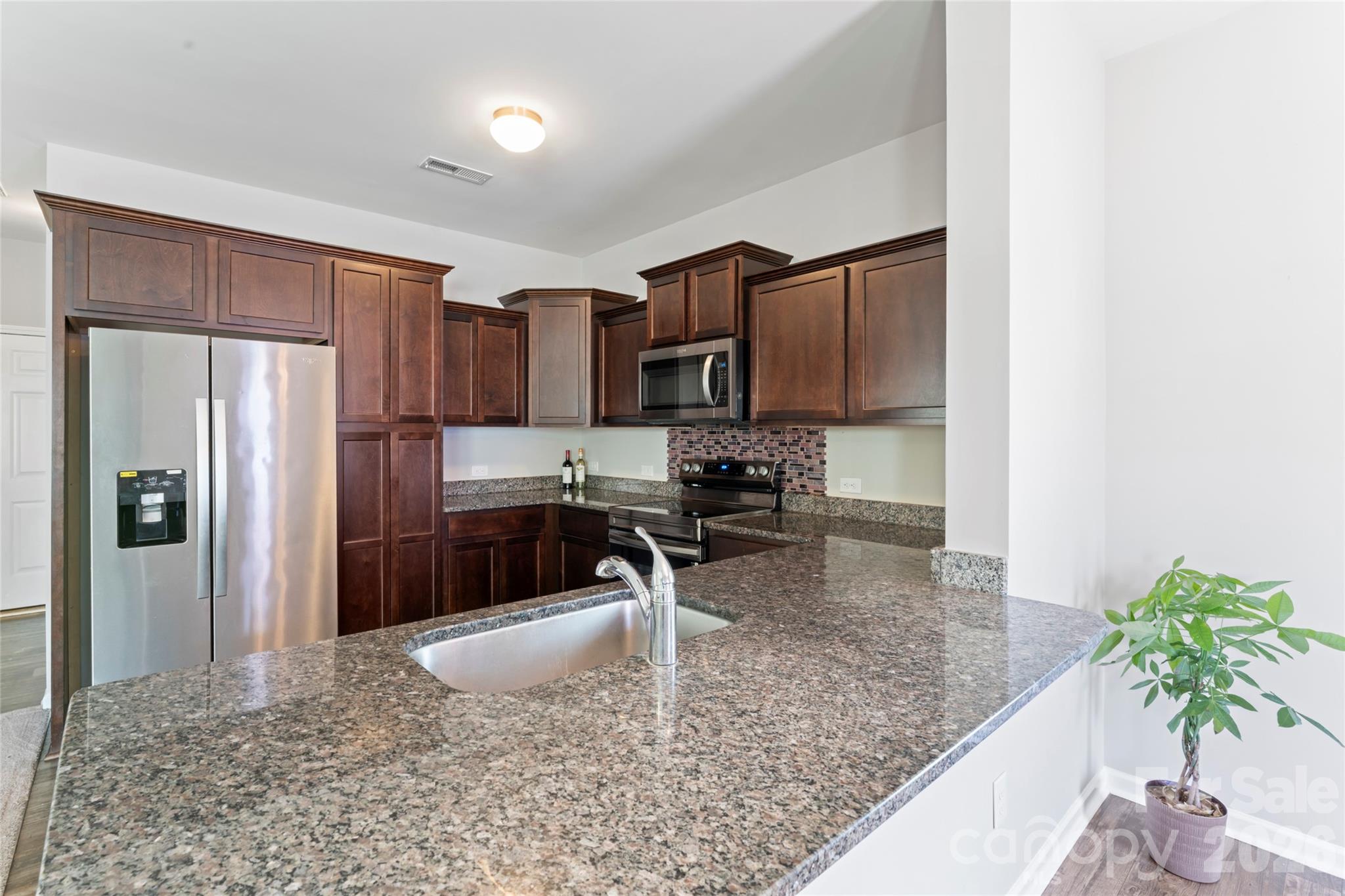 12561 Garron Road Midland, NC 28107 - Photo 12 of 36 a kitchen with stainless steel appliances granite countertop a refrigerator a stove and a sink