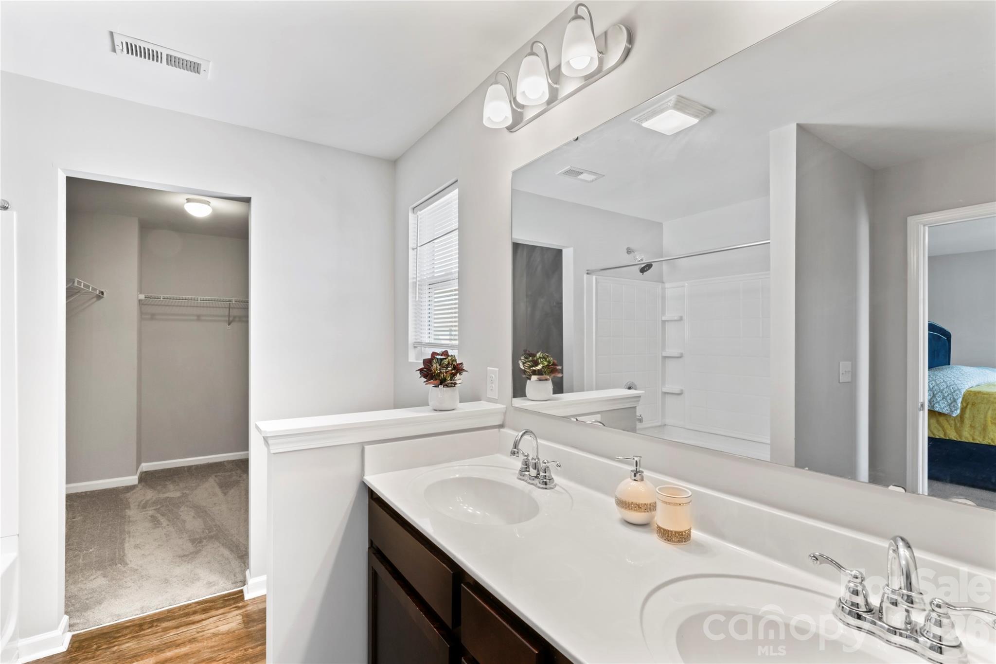 12561 Garron Road Midland, NC 28107 - Photo 20 of 36 a bathroom with a sink double vanity and a mirror