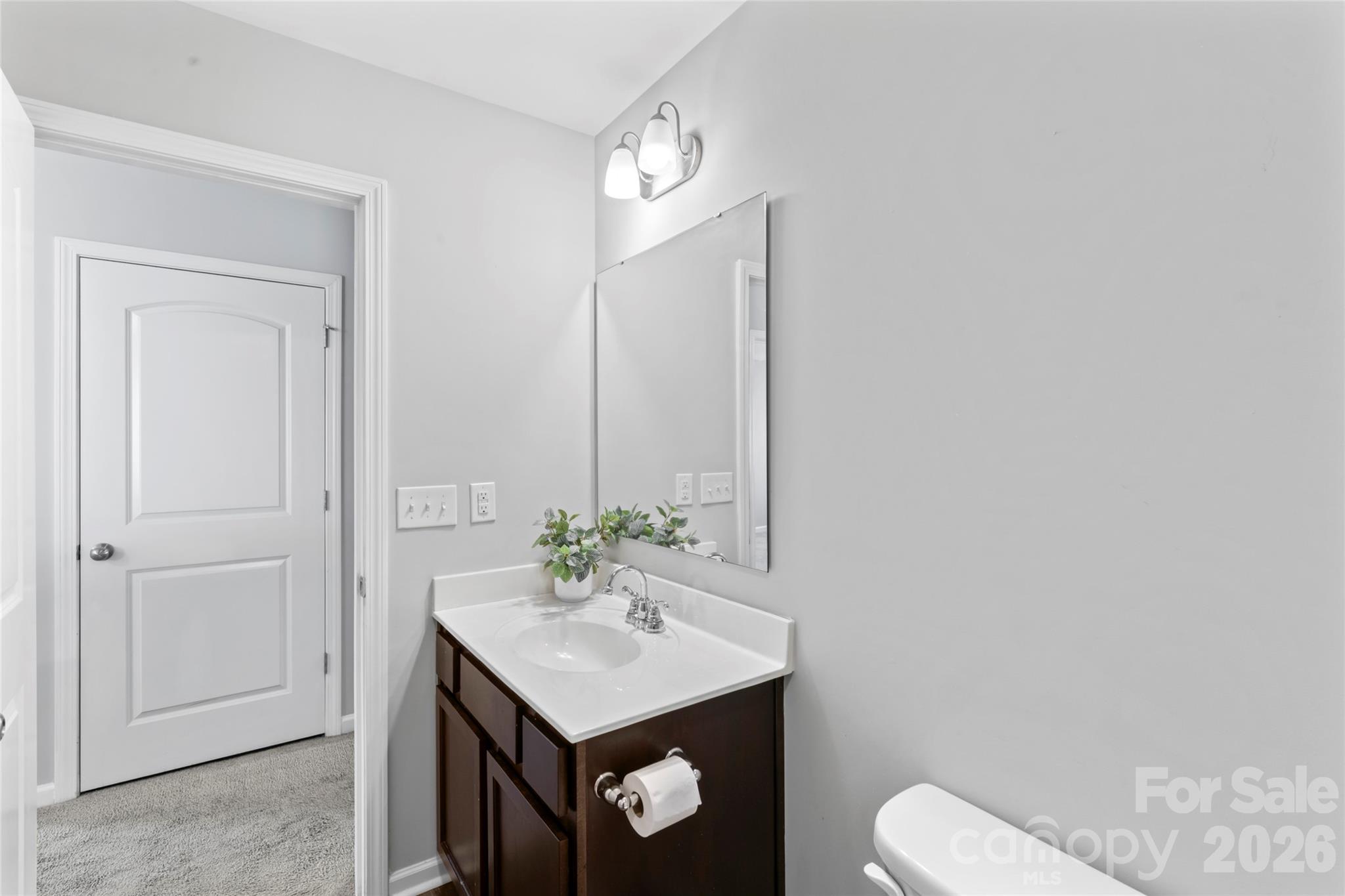 12561 Garron Road Midland, NC 28107 - Photo 25 of 36 a bathroom with a sink vanity and toilet