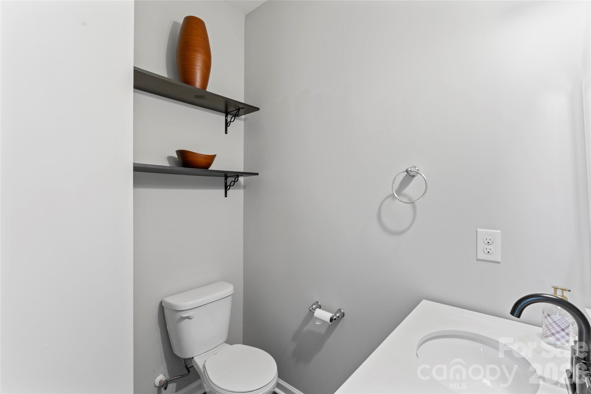 12561 Garron Road Midland, NC 28107 - Photo 27 of 36 a bathroom with a toilet sink and vanity