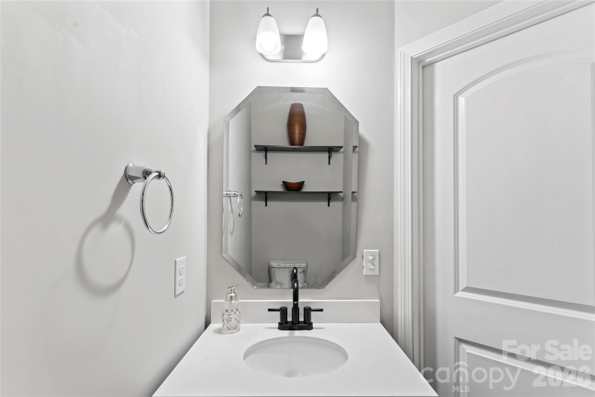 12561 Garron Road Midland, NC 28107 - Photo 28 of 36 a bathroom with a sink a mirror and vanity