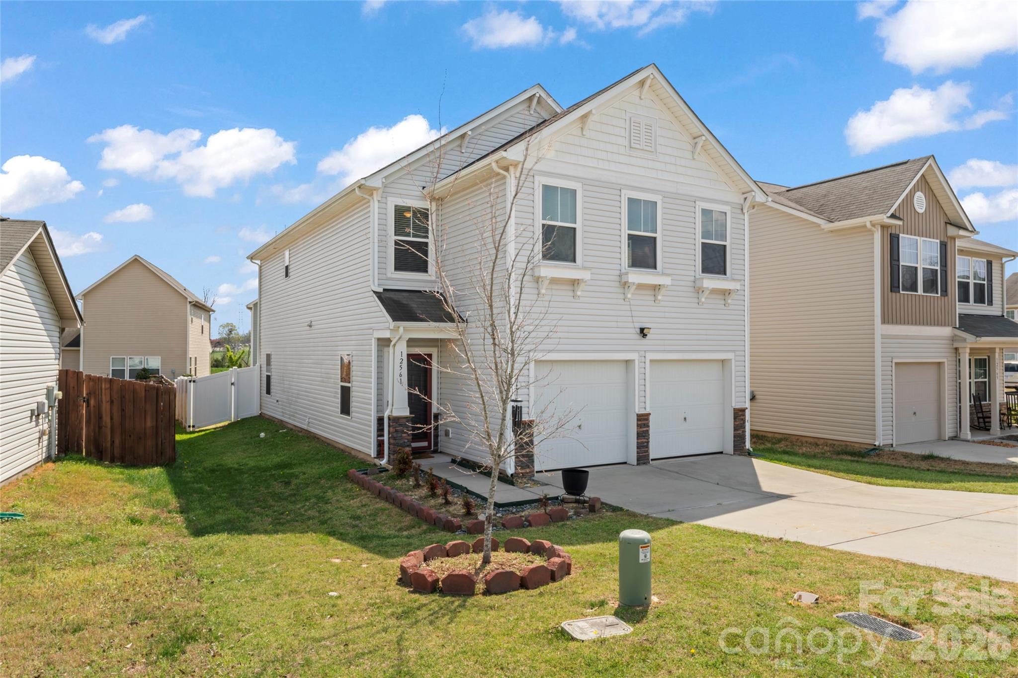 12561 Garron Road Midland, NC 28107 - Photo 3 of 36 a view of a white house with yard in front of it