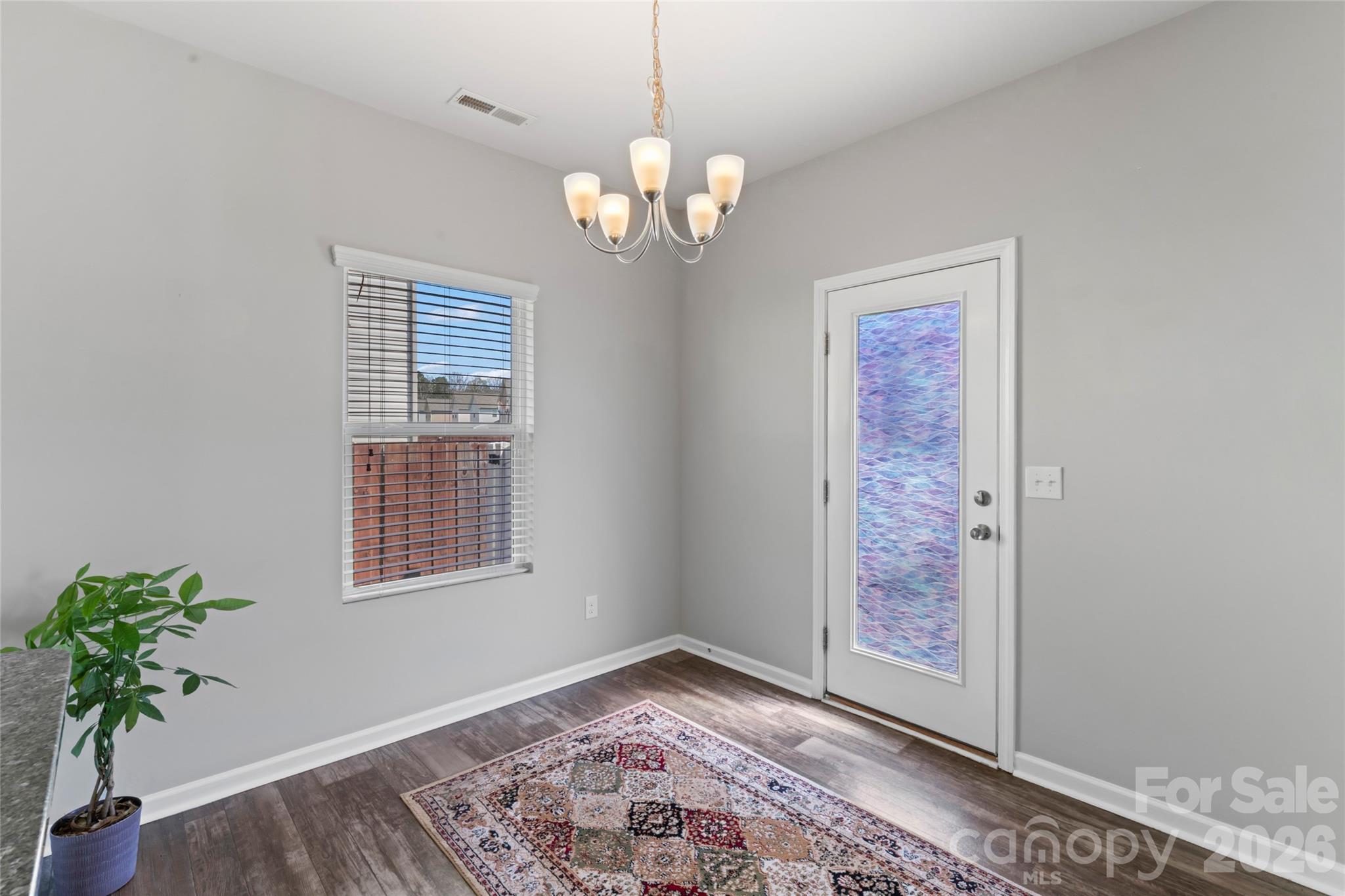12561 Garron Road Midland, NC 28107 - Photo 5 of 36 a view of an empty room with a window and wooden floor