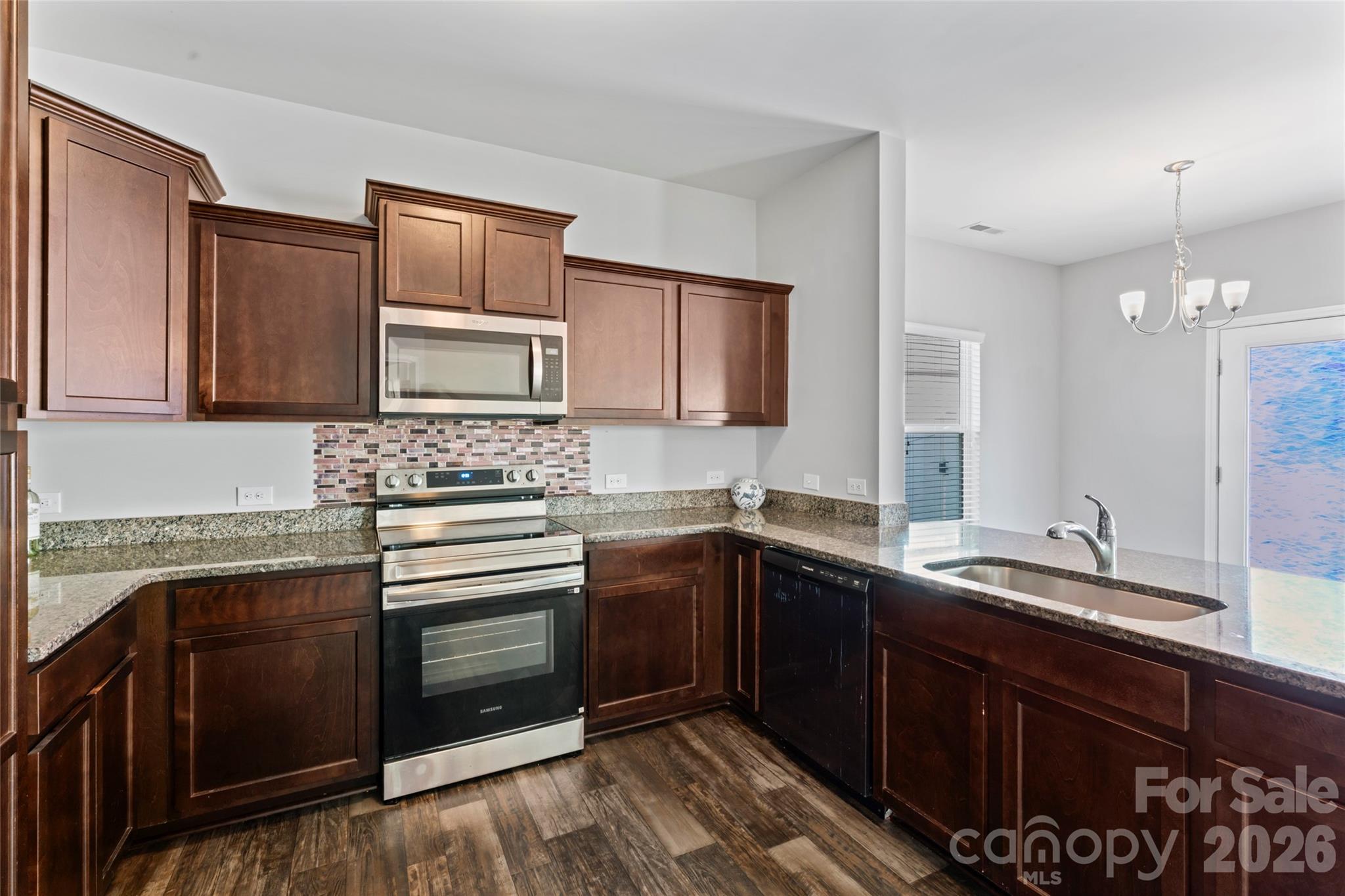 12561 Garron Road Midland, NC 28107 - Photo 9 of 36 a kitchen with a sink stove and microwave