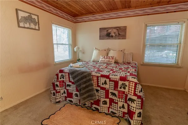 a bedroom with bed and wooden floor