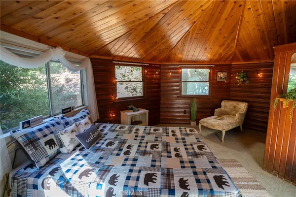 a view of a living room and floor to ceiling window in patio