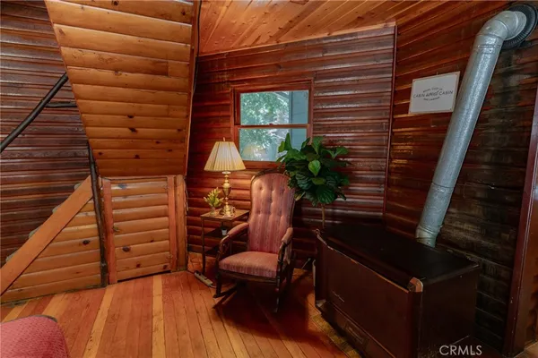 a living room with furniture a table and a large window