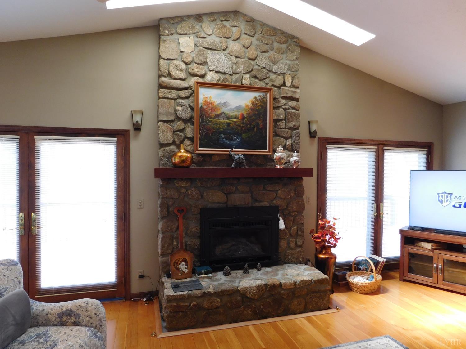 320 Ruth Drive Madison Heights, VA 24572 - Photo 19 of 60 a living room with furniture a flat screen tv and a fireplace
