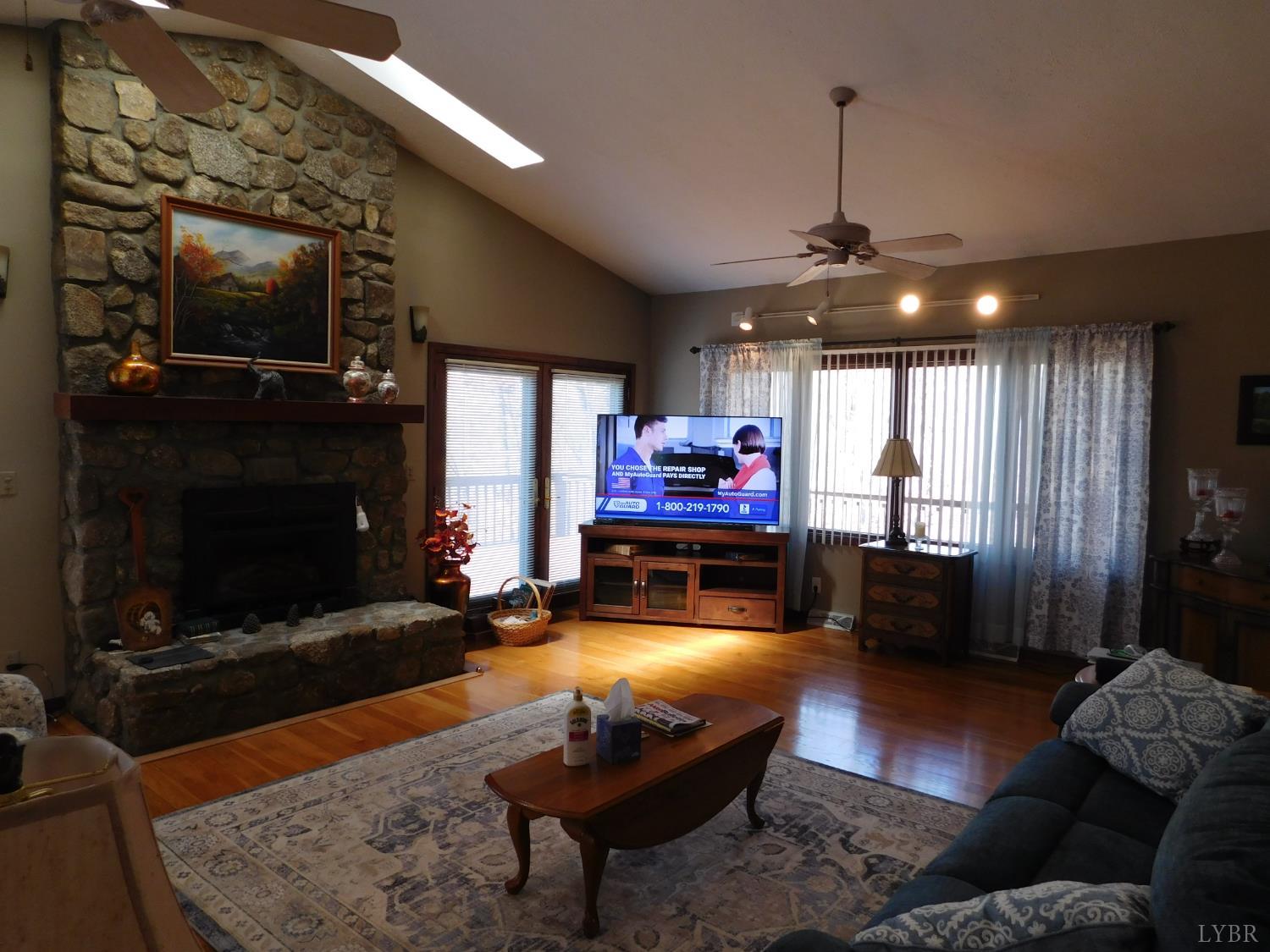 320 Ruth Drive Madison Heights, VA 24572 - Photo 21 of 60 a living room with furniture a flat screen tv and a fireplace