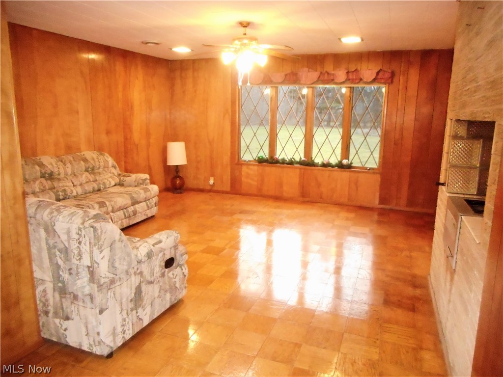 11157 County Line Road Chesterland, OH 44026 - Photo 2 of 21 Oversized Family Room with gleaming Parquet Flooring and great views of the front yard and sliders to the back! A unique built in grill could also be converted into another fireplace.
