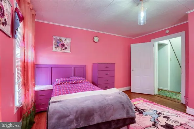 a bedroom with a bed and a dresser with mirror