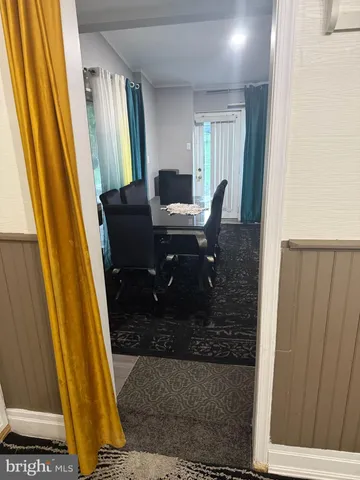 a workspace with wooden floor and a carpet