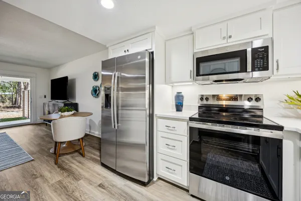 a kitchen with stainless steel appliances a stove microwave and refrigerator