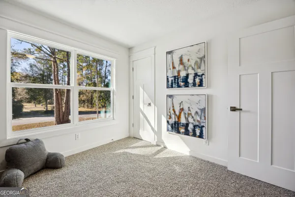 a view of a livingroom with wooden floor and a window