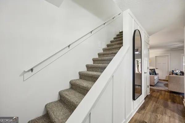 a view of entryway and hall with wooden floor