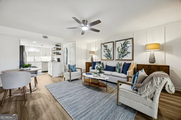 a living room with furniture and a wooden floor