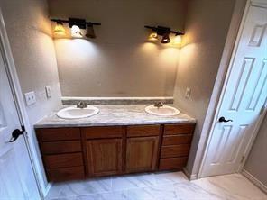 426 Gun Club Road Denison, TX 75021 - Photo 16 of 20 Primary bathroom featuring double vanity