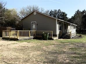426 Gun Club Road Denison, TX 75021 - Photo 4 of 20 Side view of house featuring a wooden deck