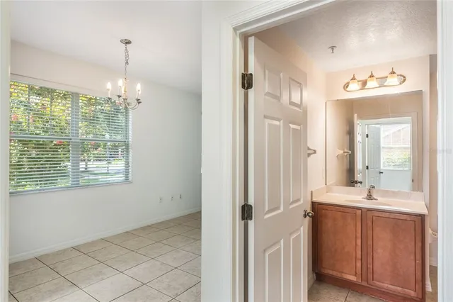 a en suite bathroom with a sink mirror and shower