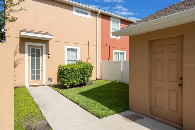 a view of a house with a small yard