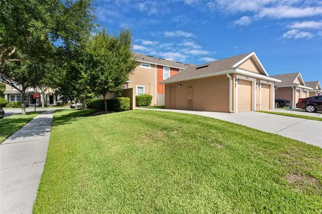 a front view of a house with a yard and trees
