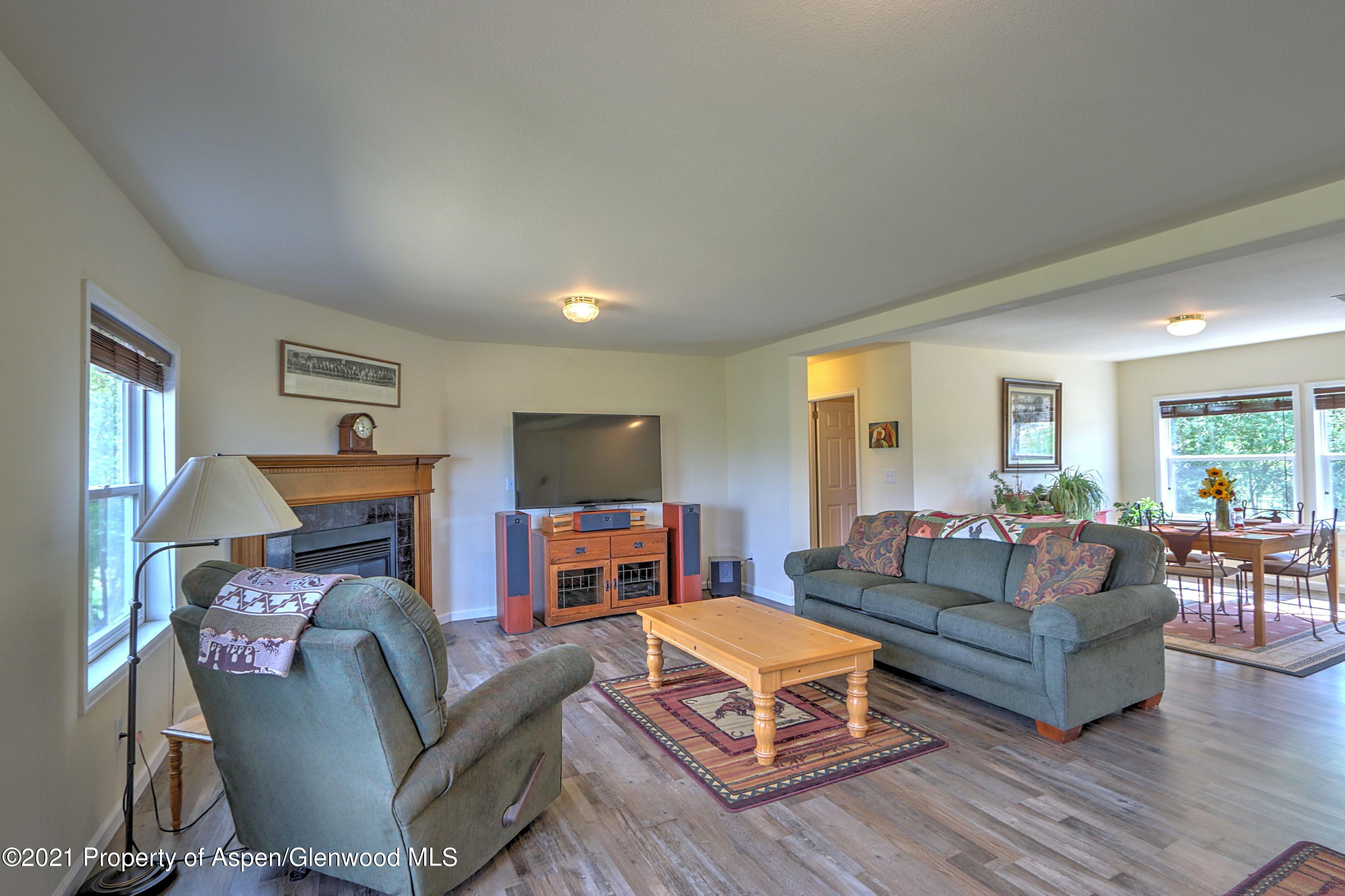 135 Swiss Lane Rifle, CO 81650 - Photo 3 of 46 a living room with fireplace furniture and a flat screen tv