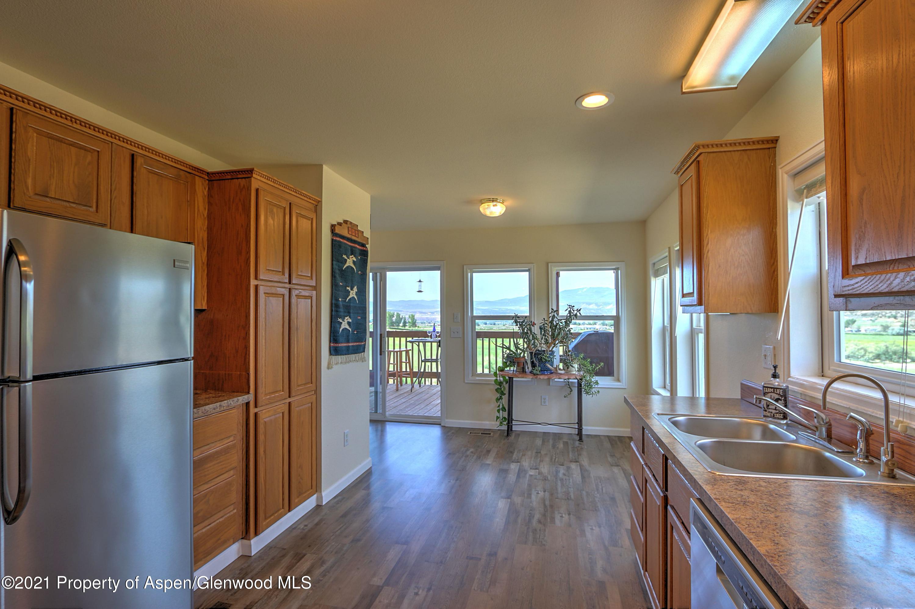 135 Swiss Lane Rifle, CO 81650 - Photo 10 of 46 a kitchen with sink refrigerator and wooden floor