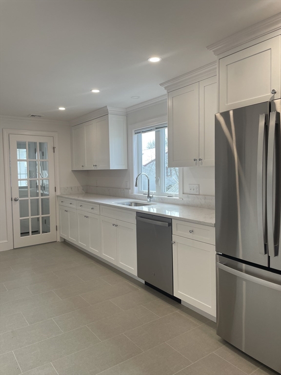29 Crescent Road, Unit 29 Belmont, MA 02478 - Photo 6 of 21 a kitchen with granite countertop white cabinets and refrigerator