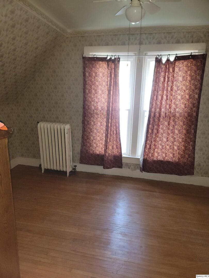 228 Wabash Avenue Carthage, IL 62321 - Photo 15 of 35 an empty room with wooden floor and windows