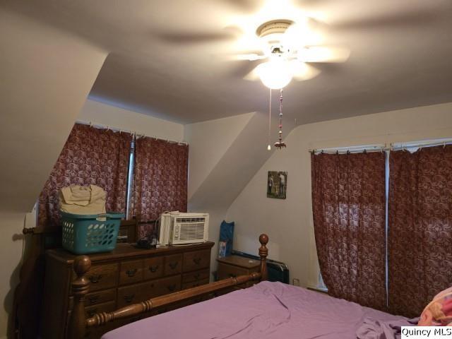 228 Wabash Avenue Carthage, IL 62321 - Photo 17 of 35 a bedroom with a bed and a chandelier