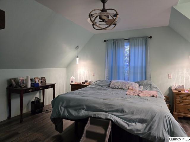 228 Wabash Avenue Carthage, IL 62321 - Photo 19 of 35 a bedroom with a bed and dresser with wooden floor