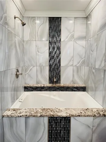 a bathroom with a granite countertop sink and a granite countertop window