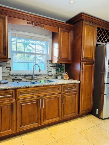 a kitchen with stainless steel appliances granite countertop a refrigerator and a sink
